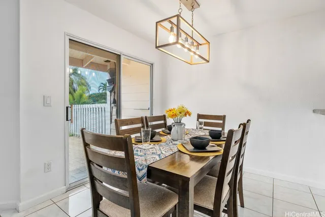 a dining room with furniture and a window