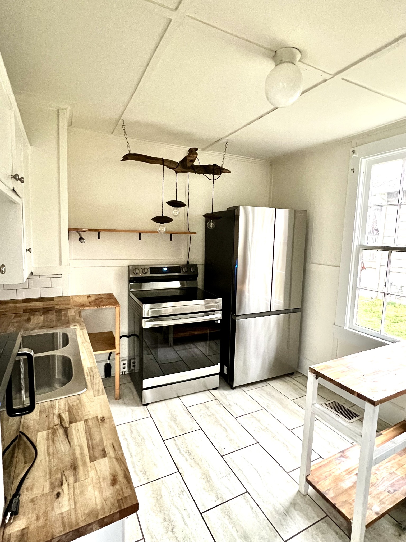 1409 Overton Street Old Hickory, TN 37138 - Photo 16 of 33 a kitchen with a refrigerator a stove a sink and a refrigerator