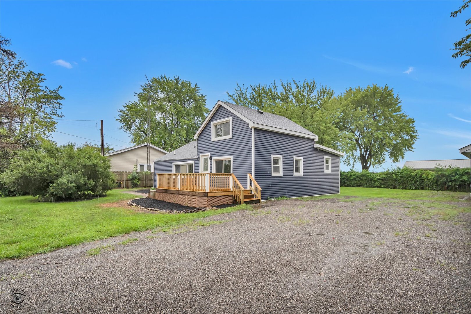 3032 West 9000N Road Manteno, IL 60950 - Photo 2 of 27 a front view of a house with a yard and garage