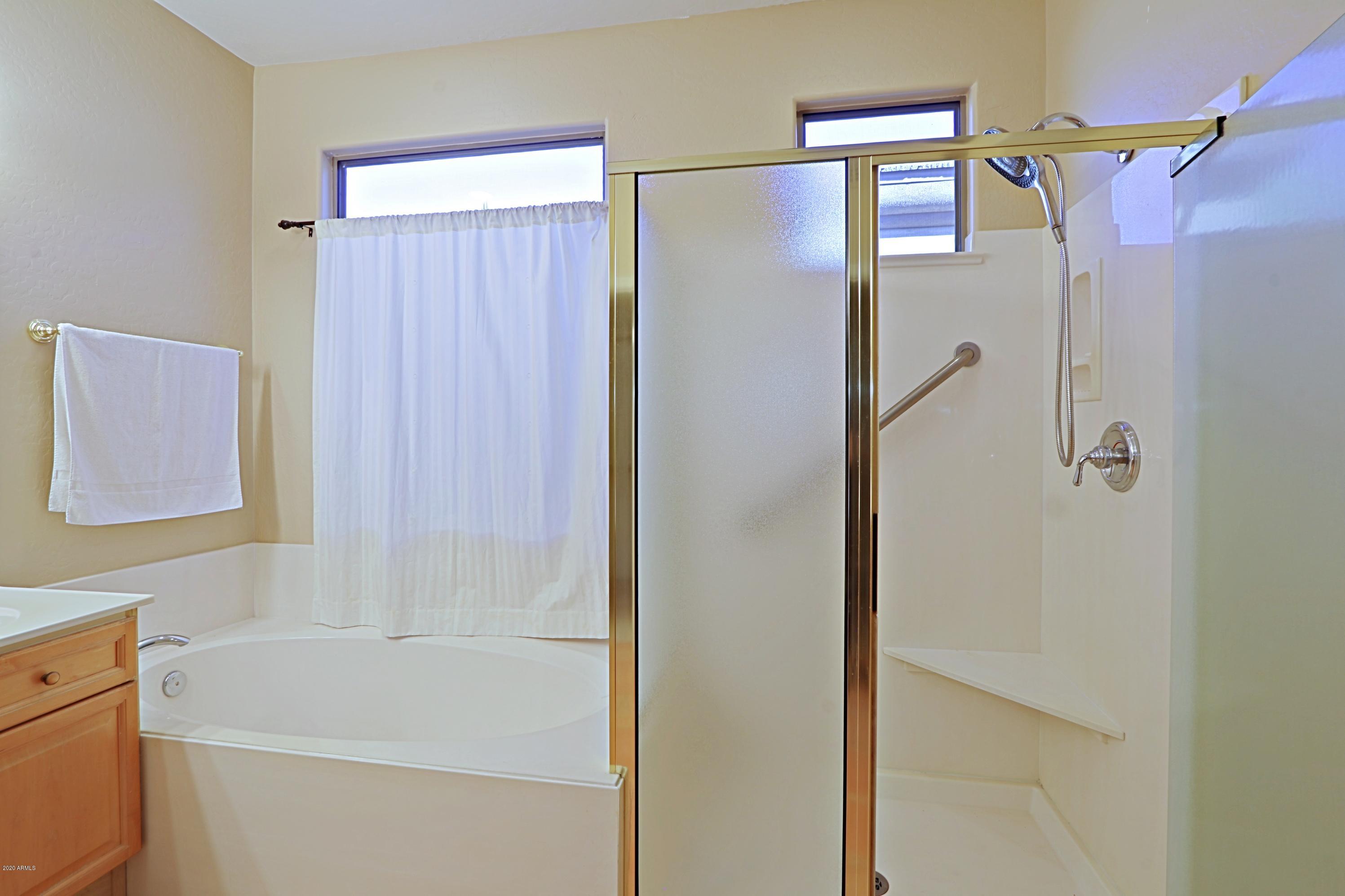 6803 East Eagle Feather Road Scottsdale, AZ 85266 - Photo 16 of 67 a bathroom with a shower and a bath tub