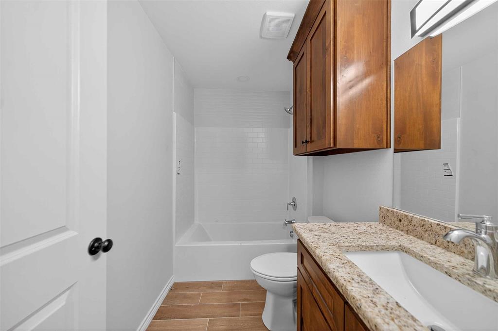 926 South Academy Avenue Tyler, TX 75701 - Photo 21 of 33 a bathroom with a granite countertop sink toilet and shower