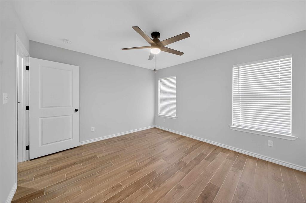926 South Academy Avenue Tyler, TX 75701 - Photo 27 of 33 a view of an empty room with wooden floor and a window