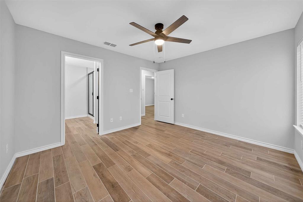 926 South Academy Avenue Tyler, TX 75701 - Photo 29 of 33 a view of an empty room with wooden floor and a ceiling fan