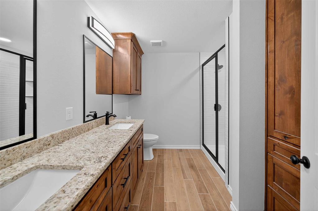 926 South Academy Avenue Tyler, TX 75701 - Photo 32 of 33 a bathroom with a granite countertop sink a vanity and shower