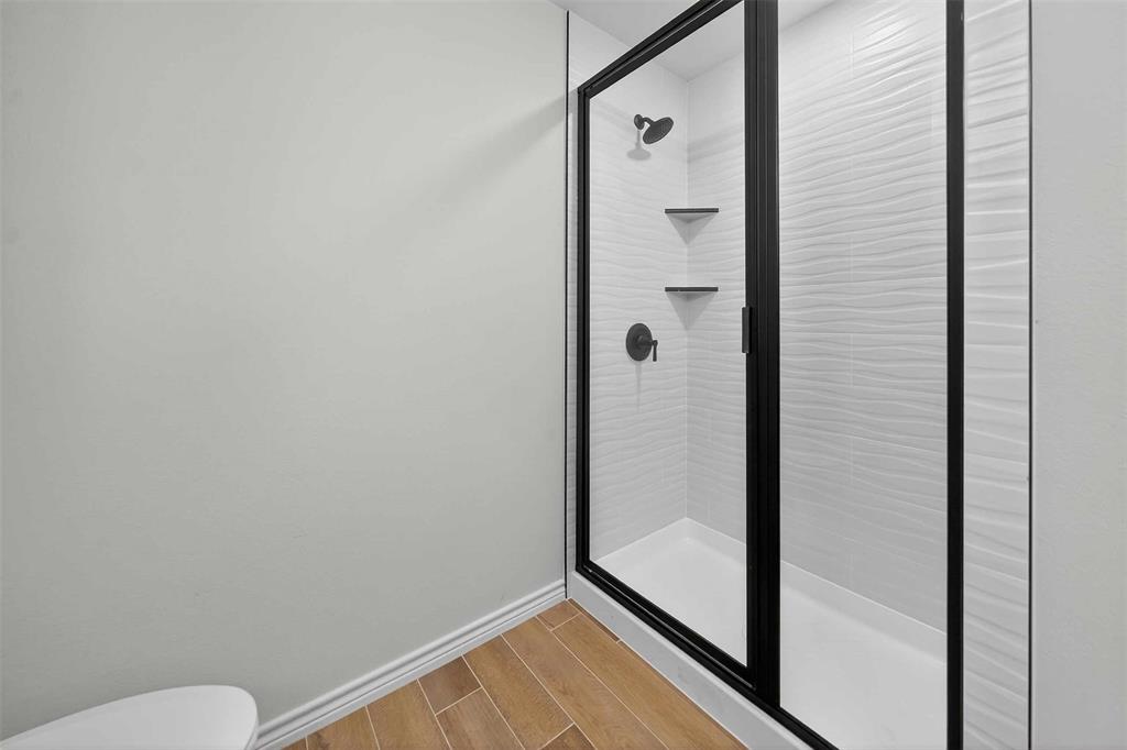 926 South Academy Avenue Tyler, TX 75701 - Photo 33 of 33 a bathroom with a glass shower door