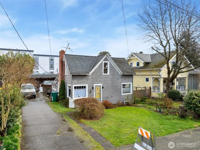 a front view of a house with a garden and plants