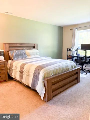 a bedroom with a bed and a night stand