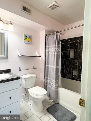 a bathroom with a toilet a sink and bathtub