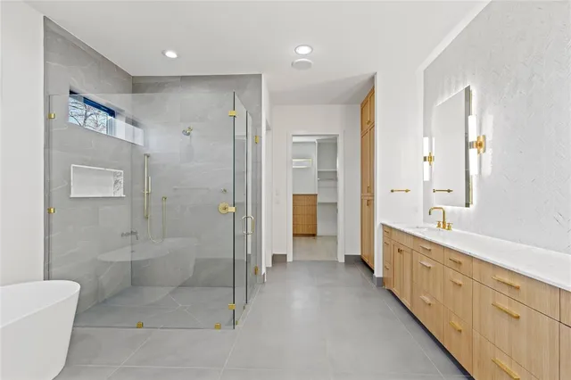 a bathroom with a double vanity sink toilet and shower