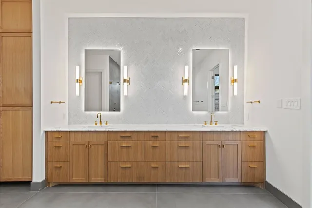 a spacious bathroom with a granite countertop sink and a mirror