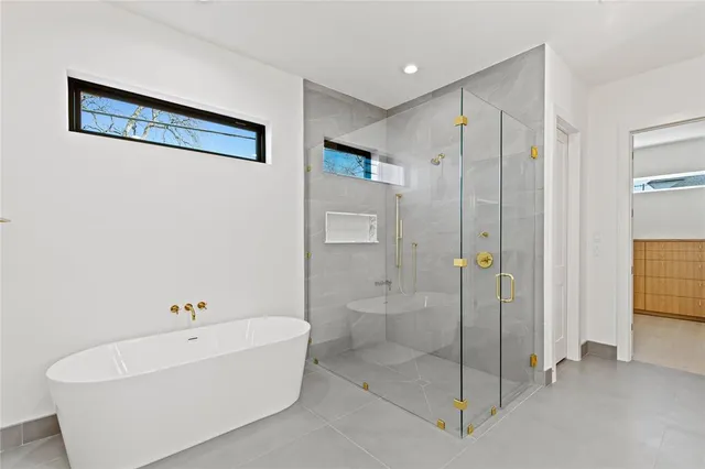 a bathroom with a bathtub and a shower
