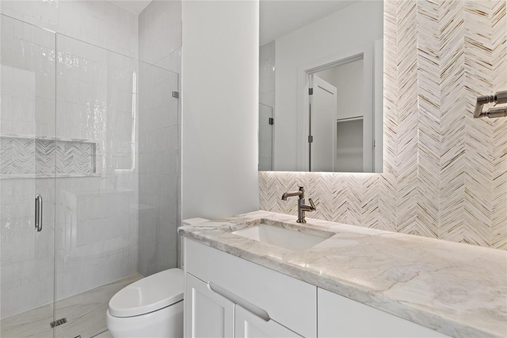 7624 Roper Street Dallas, TX 75209 - Photo 21 of 36 a bathroom with a granite countertop sink a toilet and shower
