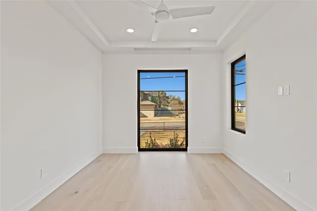 an empty room with windows and closet