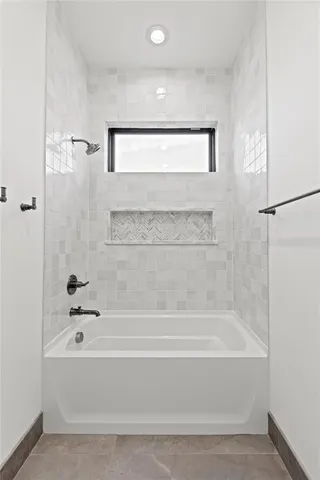 a bathroom with a bathtub and a shower