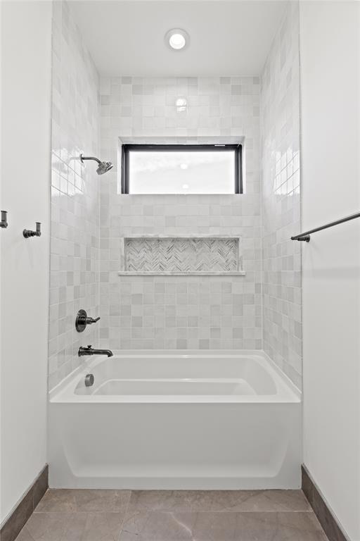 7624 Roper Street Dallas, TX 75209 - Photo 26 of 36 a bathroom with a bathtub and a shower