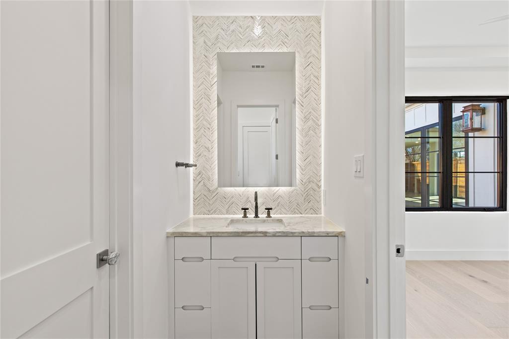 7624 Roper Street Dallas, TX 75209 - Photo 27 of 36 a bathroom with a granite countertop sink and a mirror