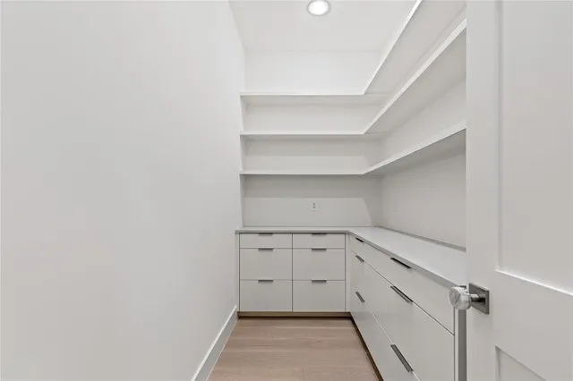 a view of a kitchen with white cabinets