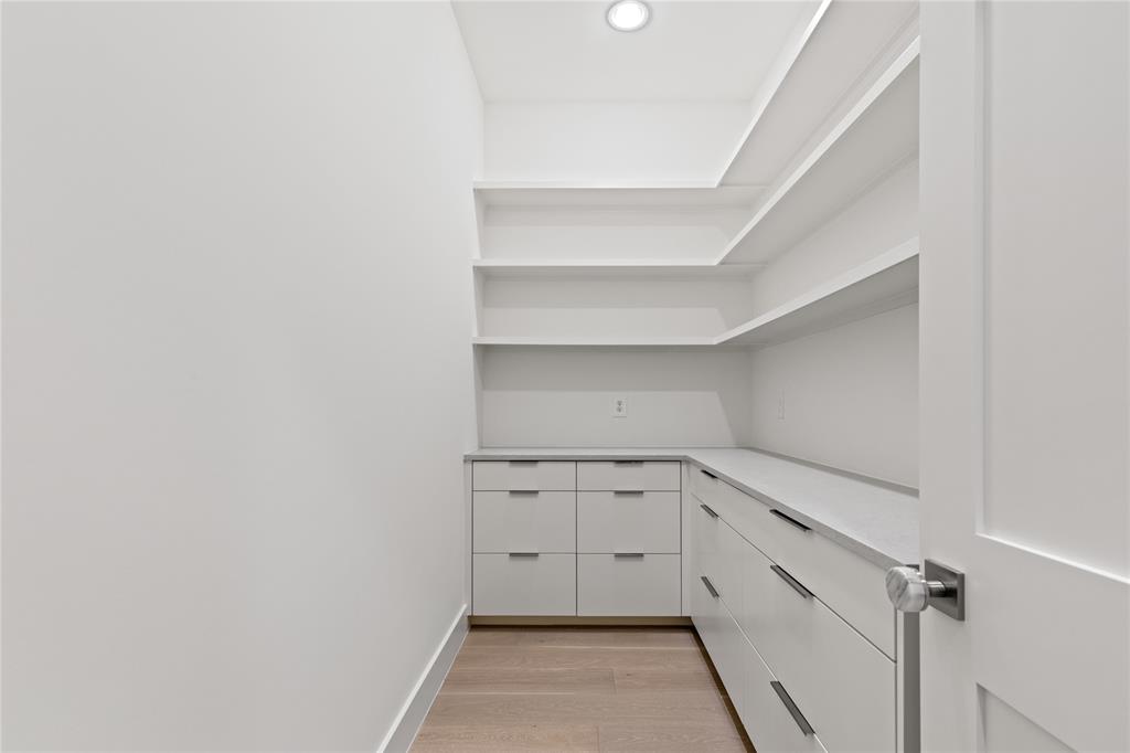 7624 Roper Street Dallas, TX 75209 - Photo 30 of 36 a view of a kitchen with white cabinets