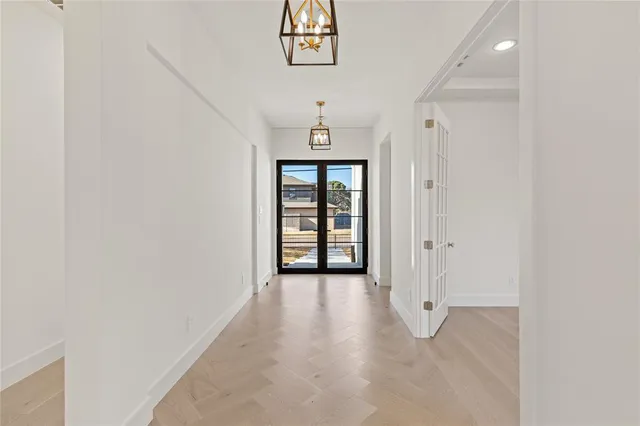 an empty room with windows and cabinet