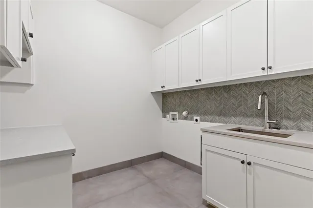 a kitchen with a sink and cabinets