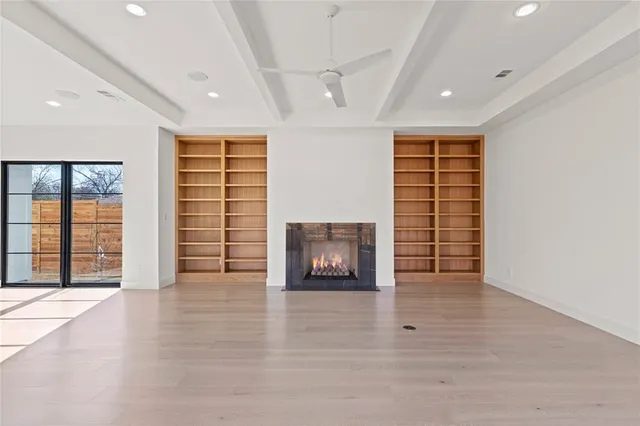 an empty room with windows and cabinet