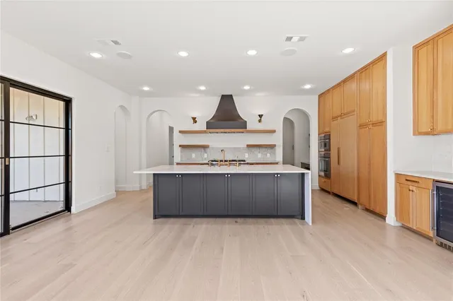 a kitchen with stainless steel appliances granite countertop a stove and a refrigerator