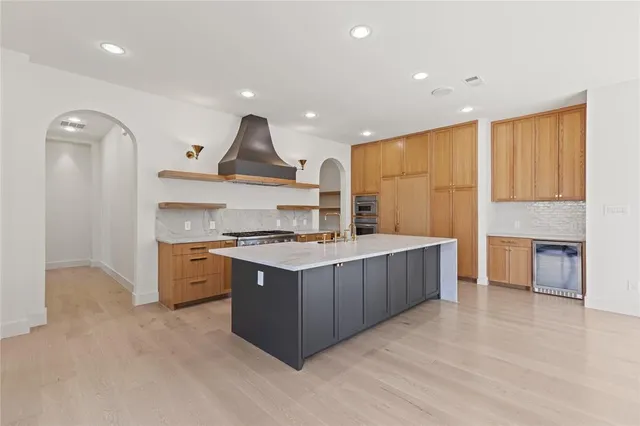 a kitchen with stainless steel appliances granite countertop a stove and a refrigerator