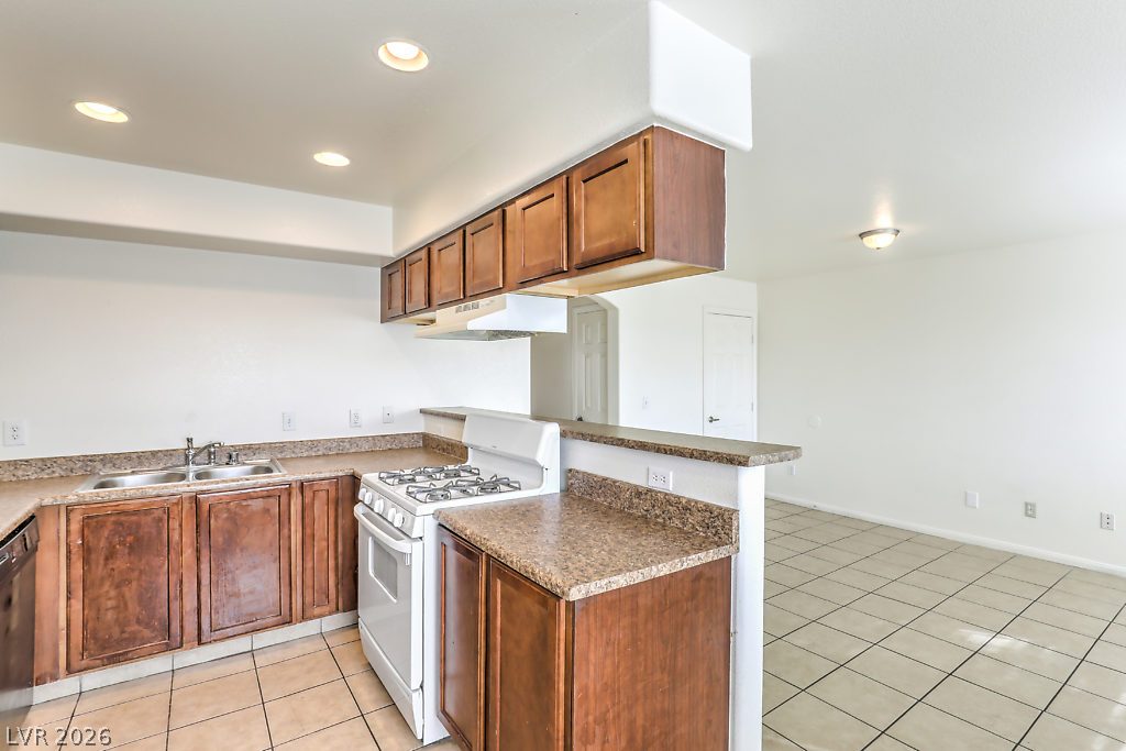 3127 North Walnut Road, Unit A Las Vegas, NV 89115 - Photo 8 of 12 A functional kitchen boasts ample cabinetry and essential appliances for daily living.