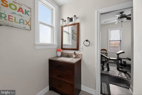 a bathroom with a sink a mirror and a window