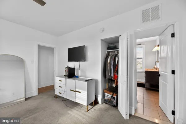a view of a bedroom with walk in closet