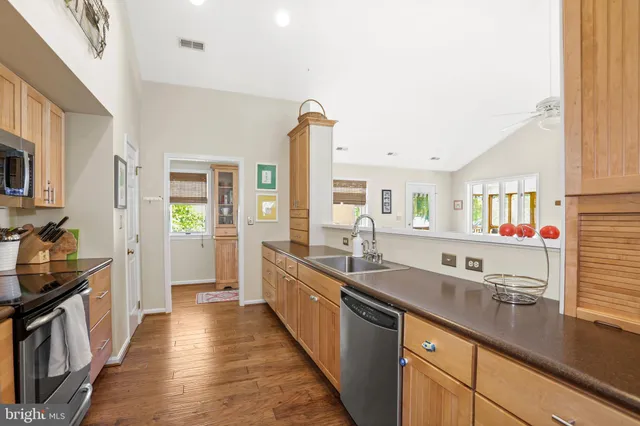 a kitchen with granite countertop a refrigerator stove and microwave