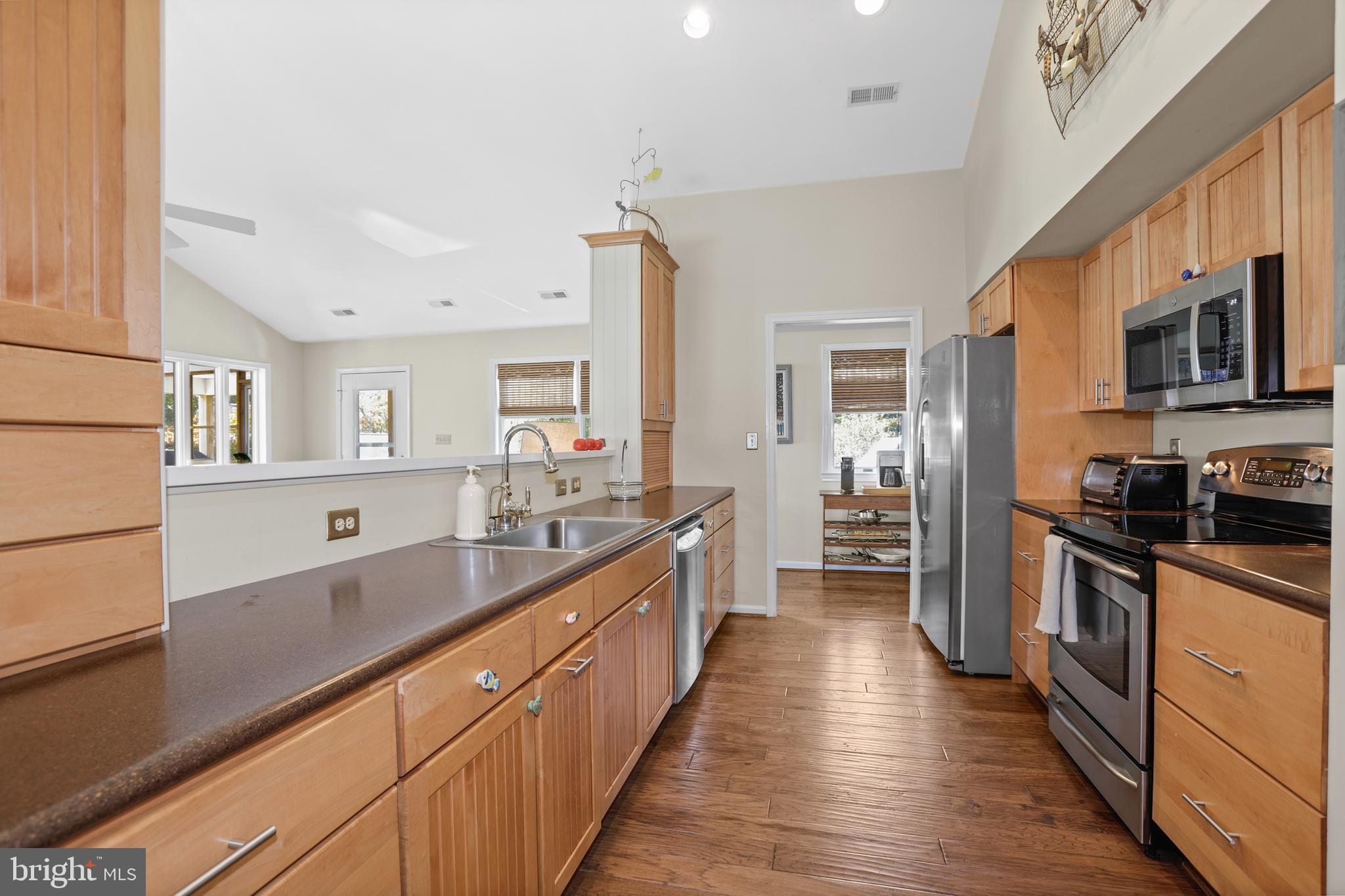 638 Marlborough Point Road Stafford, VA 22554 - Photo 16 of 58 a large kitchen with stainless steel appliances granite countertop a lot of counter space and wooden floor