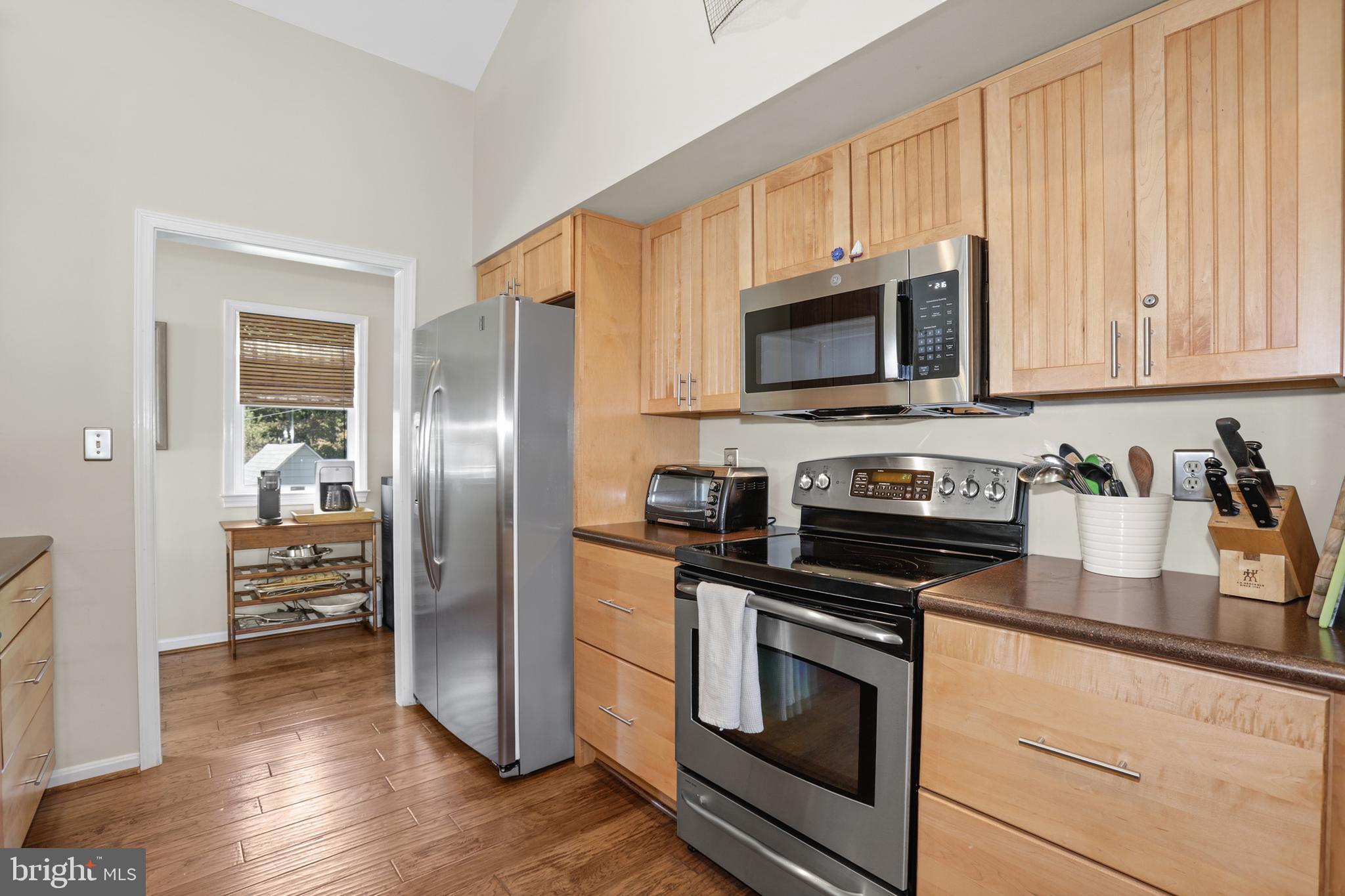 638 Marlborough Point Road Stafford, VA 22554 - Photo 17 of 58 a kitchen with granite countertop a refrigerator stove and microwave