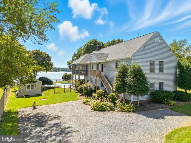 a view of a dining room with furniture large windows and wooden floor