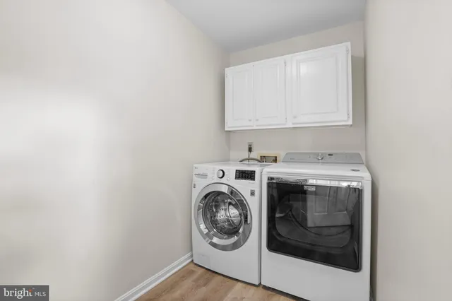 a sitting area with furniture and wooden floor