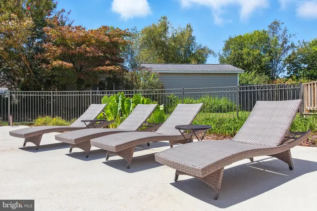 a view of a house with swimming pool and sitting area