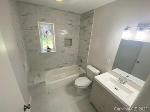 911 Scaleybark Road Charlotte, NC 28209 - Photo 11 of 22 a bathroom with a sink a toilet and bathtub