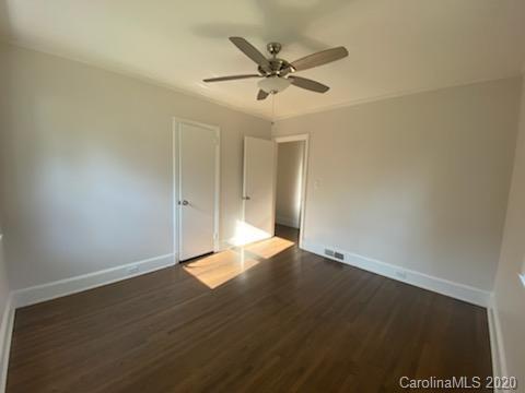 911 Scaleybark Road Charlotte, NC 28209 - Photo 14 of 22 an empty room with wooden floor fan and windows