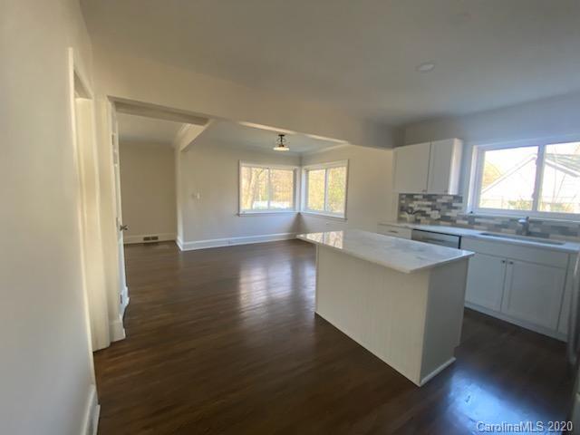 911 Scaleybark Road Charlotte, NC 28209 - Photo 4 of 22 an open kitchen with wooden floor and a window