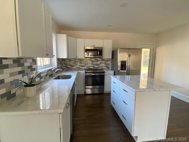 911 Scaleybark Road Charlotte, NC 28209 - Photo 5 of 22 a large kitchen with stainless steel appliances granite countertop a stove and a sink