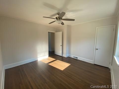 911 Scaleybark Road Charlotte, NC 28209 - Photo 7 of 22 an empty room with wooden floor closet and windows