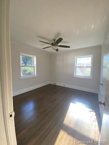 911 Scaleybark Road Charlotte, NC 28209 - Photo 9 of 22 wooden floor in an empty room with a window