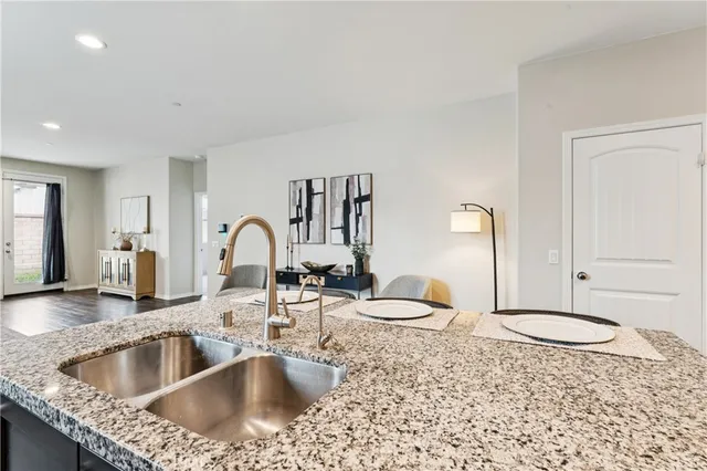 a kitchen with a dining table chairs refrigerator and cabinets