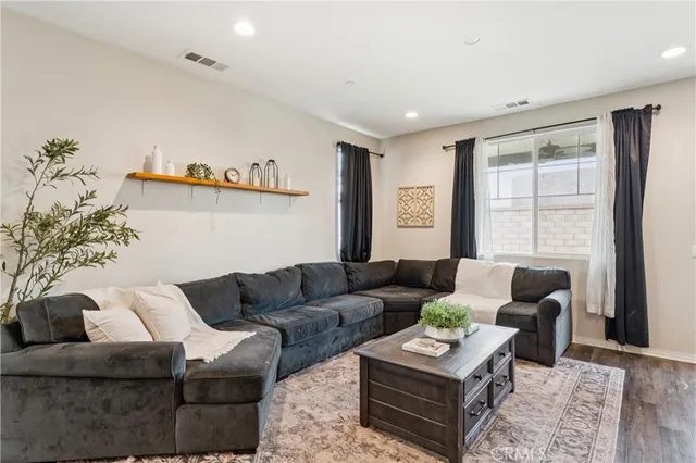 a view of a living room kitchen and a wooden floor
