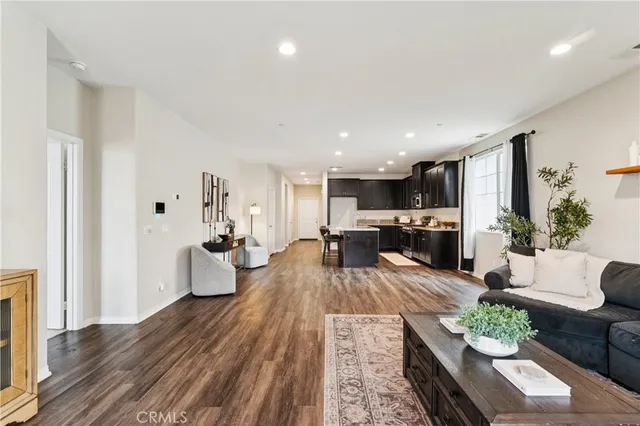 a living room with furniture kitchen view and a table