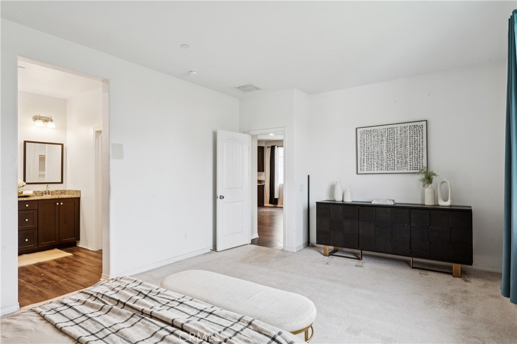 30535 Ridgely Way Menifee, CA 92584 - Photo 26 of 37 a bedroom with furniture and a bathroom