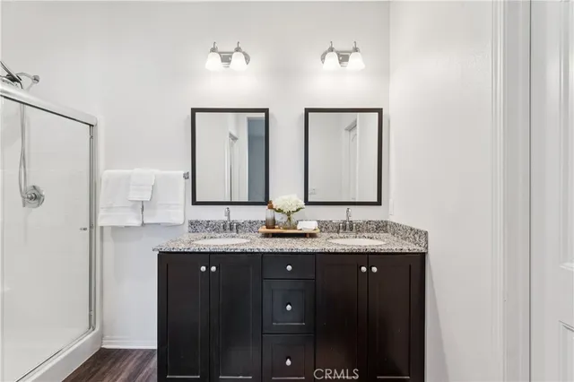 a bathroom with a granite countertop sink mirror and double