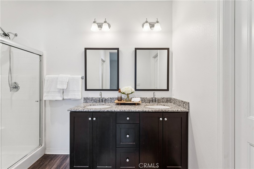 30535 Ridgely Way Menifee, CA 92584 - Photo 27 of 37 a bathroom with double vanity sinks and a mirror