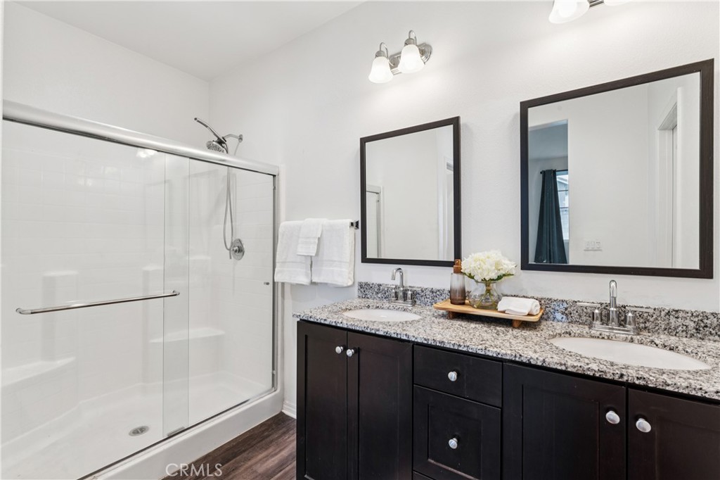 30535 Ridgely Way Menifee, CA 92584 - Photo 28 of 37 a bathroom with a granite countertop sink mirror and double