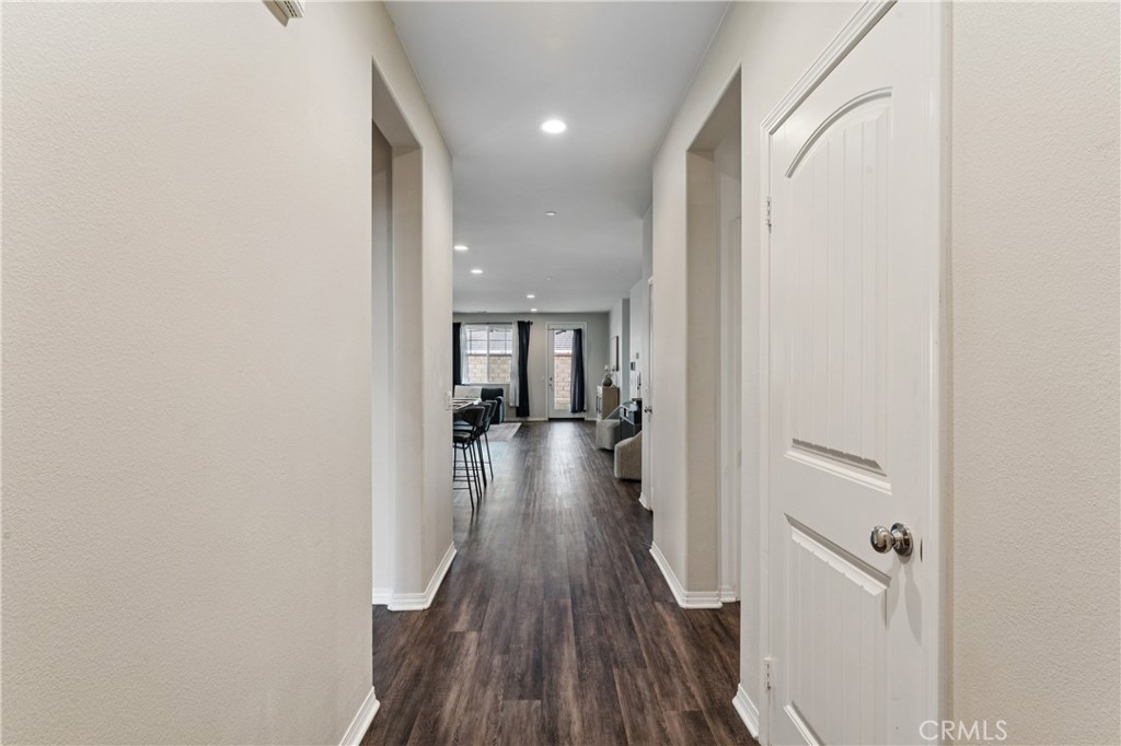 30535 Ridgely Way Menifee, CA 92584 - Photo 5 of 37 a view of a hallway with wooden floor and staircase